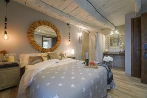 A PontenovaComplejo Rural Lar de Vies的一间卧室配有一张大床和镜子