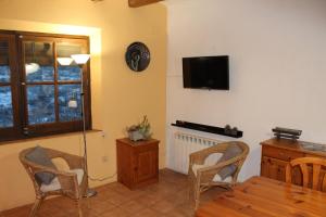 SenantCa la Nuri的客厅配有桌椅和电视。