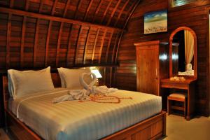 珀尼达岛Setilas Bungalows的一间卧室配有一张床,床上有毛巾
