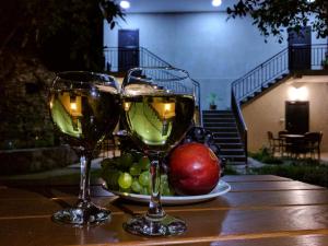 阿哈尔齐赫Hotel Beni的两杯酒坐在桌子上,配水果