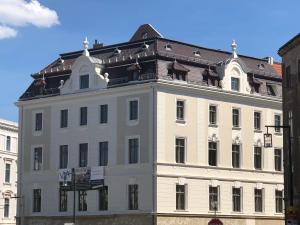 格尔利茨VIA`s Appartements und Ferienwohnungen的白色的大建筑,带有棕色的屋顶