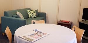 奥尔巴尼公园大道假日酒店的客厅配有桌子和绿色沙发