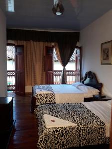 SalaminaBonsai Hotel Salamina Caldas的一张带豹纹的房间里两张床铺