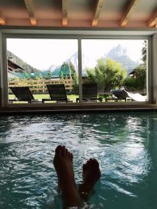 博萨迪法萨埃尔帕斯特酒店的脚踏入游泳池的人
