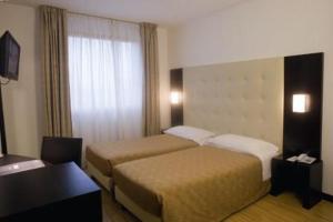 蒙泰基奥马焦雷圣马可酒店的酒店客房设有两张床和窗户。