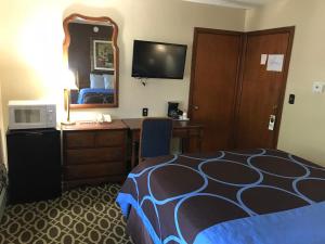 Marinette马里内特经济旅馆的酒店客房带一张床、一张书桌和一面镜子