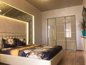 哈尔科夫Luxury Apartment in Downtown, Near River Esplanade的一间卧室配有一张特大号床和一个衣柜