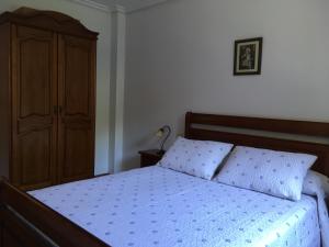 苏加拉穆尔迪Bizentenea的一间卧室配有一张床、梳妆台和一张床