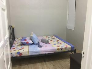 马六甲Taman Rambai Homestay的小房间的小床,床罩