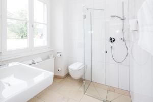 布雷根茨Hotel Gasthof Lamm的带淋浴和卫生间的白色浴室