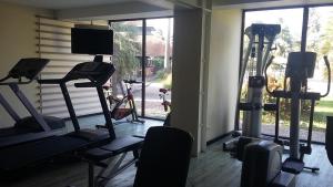 卡宴Grand Hotel Montabo的健身房设有两台跑步机和大窗户