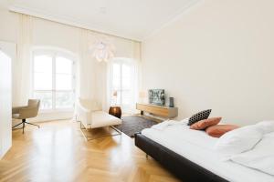 美因茨奥斯特纳霍夫套房公寓的白色卧室配有床和椅子