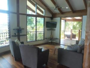 Cow BayDaintree Holiday Homes - Yurara的带沙发和平面电视的客厅