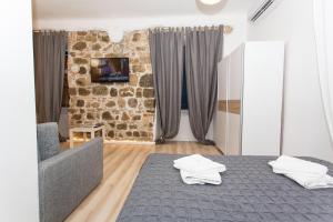 里耶卡Apartment Stara vrata的一间卧室设有一张床和石墙