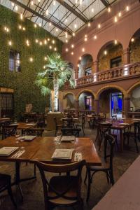 阿特利斯科Alqueria de Carrion Hotel Boutique的一间带桌椅和绿色墙壁的餐厅
