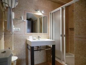 萨格里什君悦胡里奥酒店的一间带水槽、淋浴和镜子的浴室
