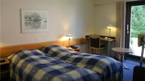 霍夫伯格克罗酒店客房内的一张或多张床位