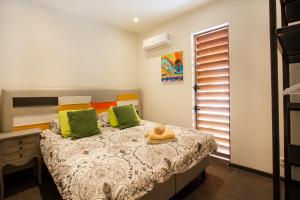 简蒂埃尔Villa Sol Paraiso的一间卧室配有带绿色和橙色枕头的床