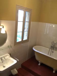 Le Bar-sur-LoupHôtel particulier des Jasmins的带浴缸、水槽和窗户的浴室