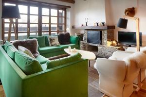 上阿兰Nin de Beret 4 by FeelFree Rentals的客厅配有绿色家具和壁炉