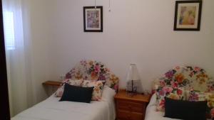 阿洛拉Casa Paquita Y Telesforo的一间卧室配有两张床和一盏灯
