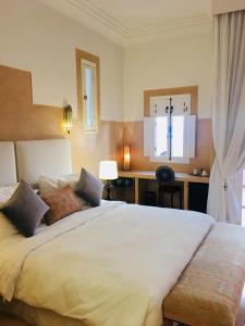 阿加迪尔里亚德斯高尔夫球酒店的卧室配有一张白色大床和一张书桌
