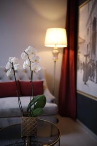 扎达尔Teatro Verdi Boutique Hotel的房间里的一张桌子上一束白色花