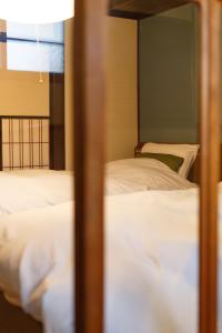 金泽Higashiyama Chitaru in Kanazawa的配有白色床单的客房内的两张床