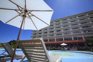 石垣岛石垣海滨酒店的酒店旁边的椅子和遮阳伞