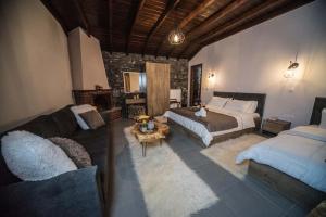 帕雷斯阿吉萨那Guesthouse Nefeli的一间卧室配有一张床、一张沙发、一张床和一台电视。