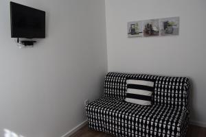 波尔图Oporto Living Apartments的一间配有电视的客房内的黑白沙发
