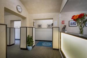 布拉格白狮酒店的走廊上设有一扇门,花瓶和钟