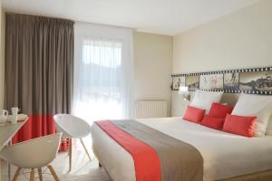 佩罗斯-吉雷克班斯贝斯特韦斯特SPA酒店的酒店客房配有一张带红色枕头的大床