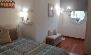 博洛尼亚Bologna Central Apartment的卧室配有床、椅子和窗户。