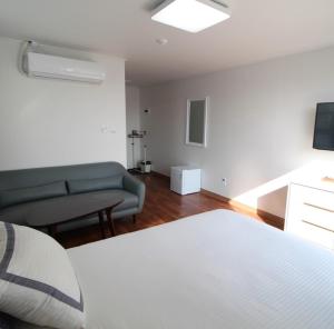 光州客人145旅馆的客房设有床、沙发和电视。