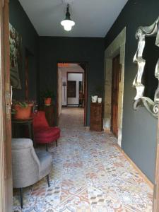 阿古伊梅斯Casa rural el Burro的走廊上,房间里摆放着沙发和椅子