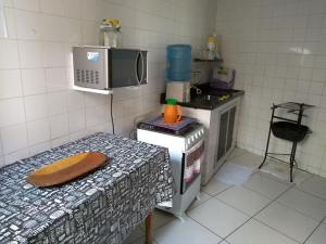 卡波布里奥Casa na Praia do Forte的带微波炉的厨房和桌子