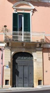 卡斯泰拉内塔B&B Palazzo Rochira的带阳台的大门建筑