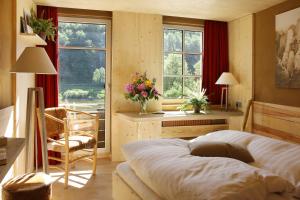 巴特尚道Bio-Hotel Helvetia的卧室配有一张床、一张书桌和窗户。