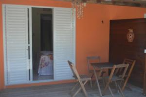 雅克南Pousada Kamaka Praia的客房设有桌椅和窗户。