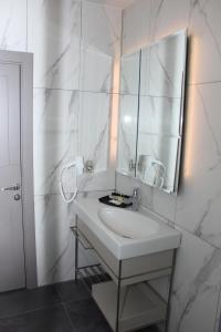 伊斯坦布尔Anka Premium Hotel的白色的浴室设有水槽和镜子