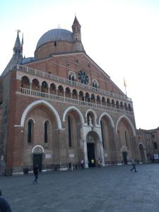 帕多瓦Ciao Amore的一座大型砖砌建筑,上面有时钟