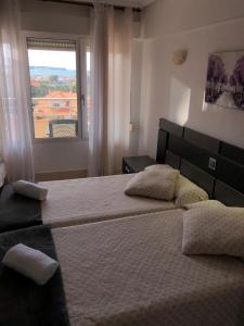 洛雷多Hotel Costa Mar的一间卧室设有两张床和窗户。