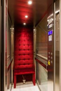 佛罗伦萨VRooms All'Angolo Del Duomo的大楼里红色的电梯,红色的座位