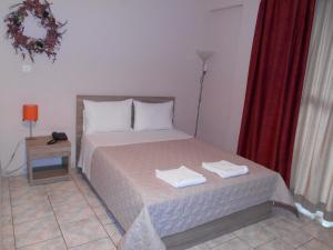 纳夫普利翁Hotel Vasilis的一间卧室配有一张床,上面有两条毛巾