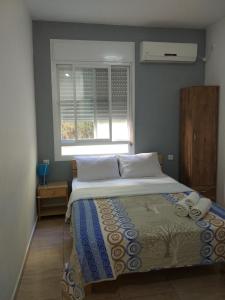 纳哈里亚嘉腾汽车旅馆的一间卧室设有一张大床和窗户