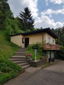 RothFerienhaus Chalet Cottage Ourtalblick 2km von Vianden-Lux的前面有楼梯的房子