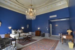 突尼斯拜拉姆宫殿酒店的一间蓝色卧室,配有一张床和一个吊灯
