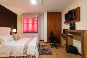 昆卡Hotel Boutique Castilla de Léon的酒店客房设有一张床和一个红色的窗户。