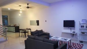 巴西古当F.A Guesthouse Pasir Gudang的客厅配有沙发和桌子